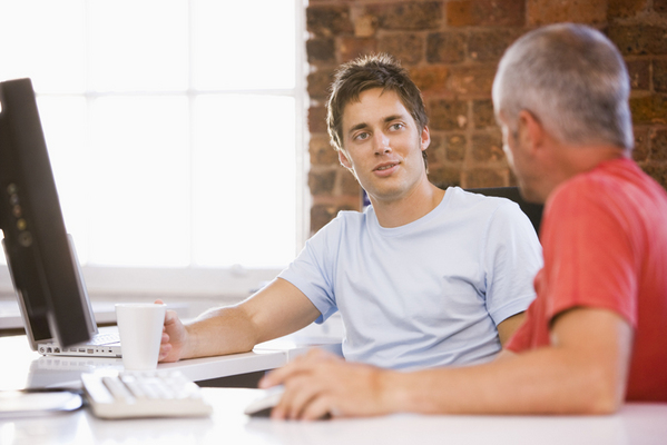 Men in Office Next to Computer on Desk